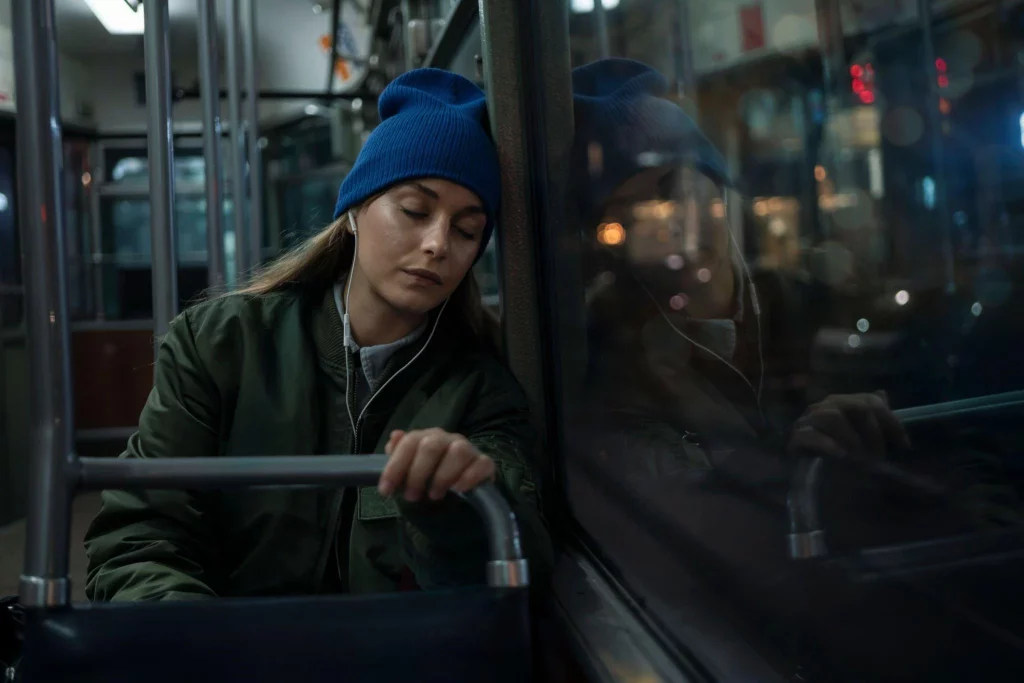 a girl sleeping comfortably on a train.